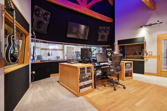 office area featuring a high ceiling and hardwood / wood-style flooring