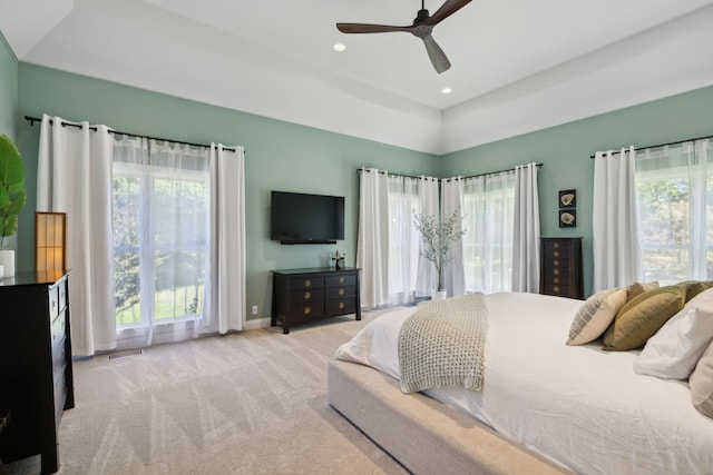 bedroom with ceiling fan and light colored carpet