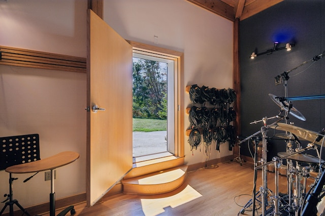 foyer entrance with beam ceiling and light hardwood / wood-style floors