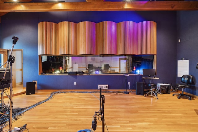 interior space with beam ceiling and wood-type flooring