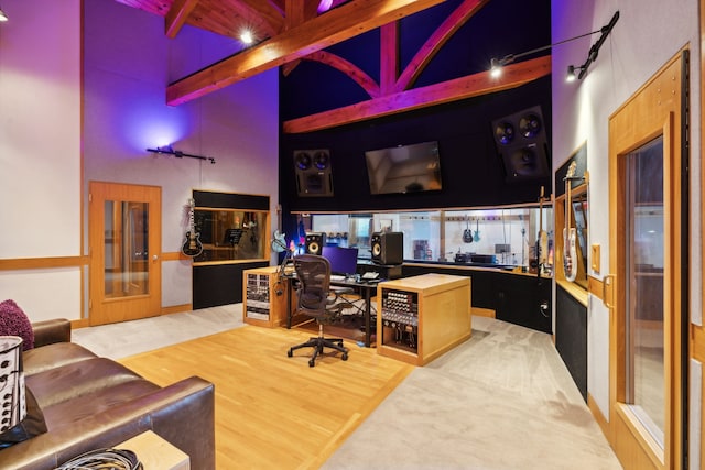 office space with beamed ceiling, french doors, hardwood / wood-style flooring, and high vaulted ceiling