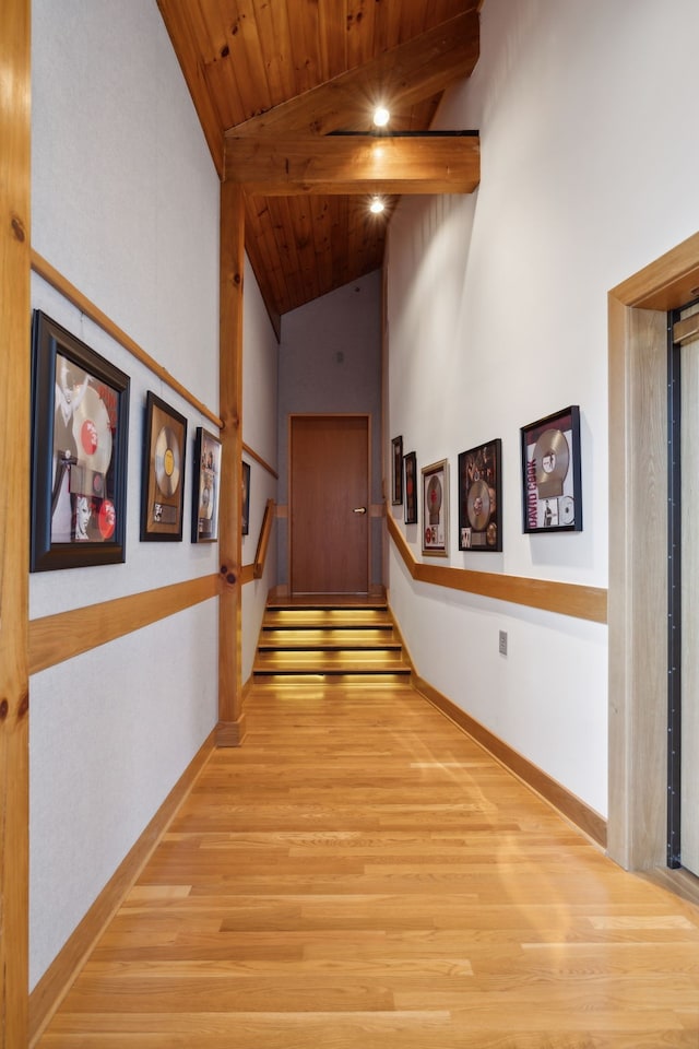 hall featuring beam ceiling, wooden ceiling, high vaulted ceiling, and light hardwood / wood-style flooring