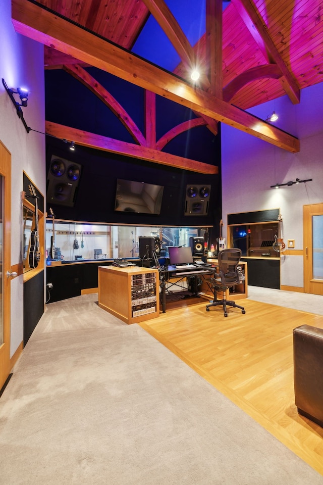 home office featuring hardwood / wood-style floors, beamed ceiling, wood ceiling, and high vaulted ceiling