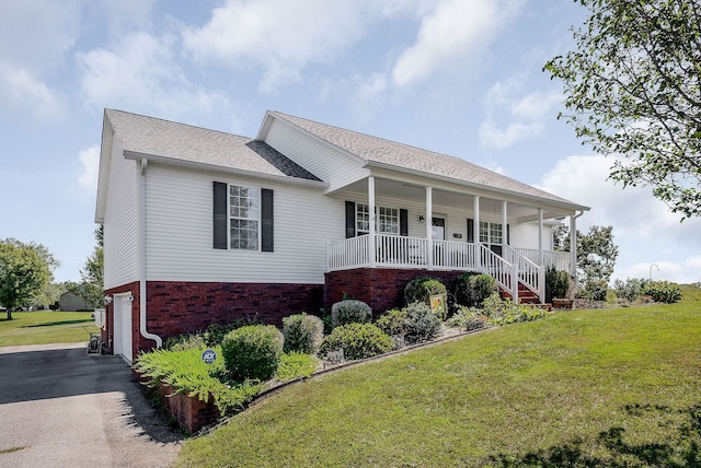 ranch-style house with a porch, a garage, and a front yard