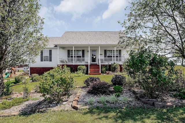 ranch-style home with covered porch and a front yard