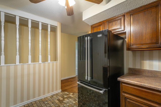 kitchen featuring black fridge, ceiling fan, and dark hardwood / wood-style flooring