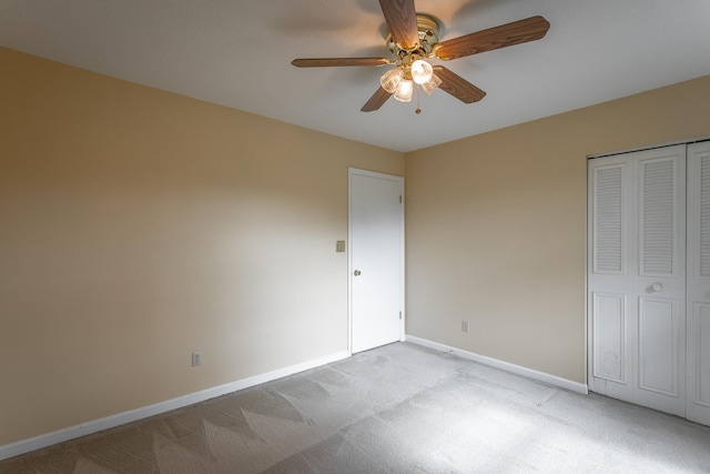 unfurnished bedroom with a closet, ceiling fan, and light colored carpet