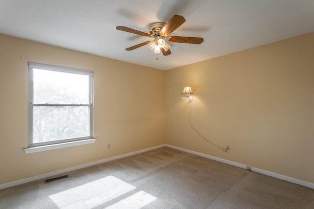 unfurnished room featuring ceiling fan and light colored carpet