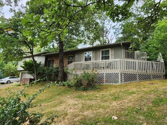 view of front of house with a front yard and a wooden deck