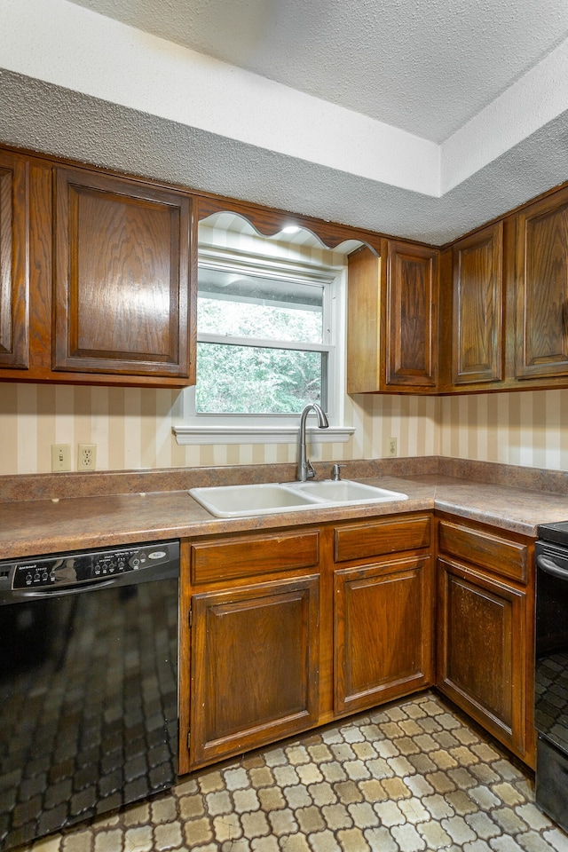 kitchen with black appliances, a textured ceiling, and sink