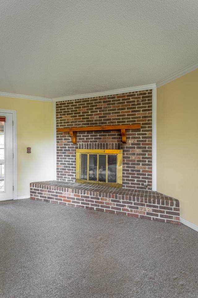 unfurnished living room with a textured ceiling, ornamental molding, a brick fireplace, and carpet floors