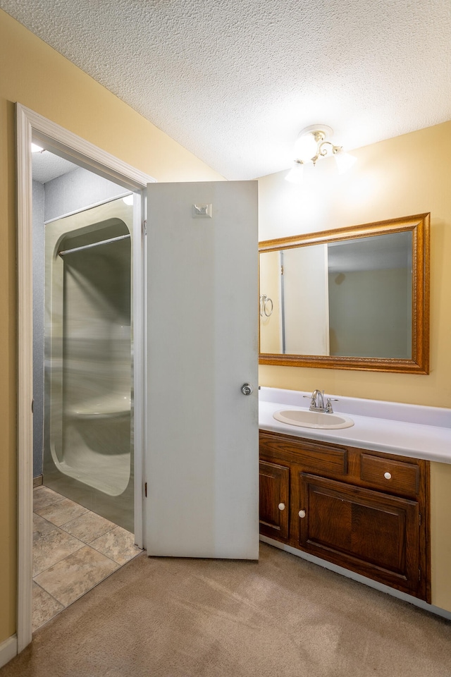 bathroom with a textured ceiling and vanity