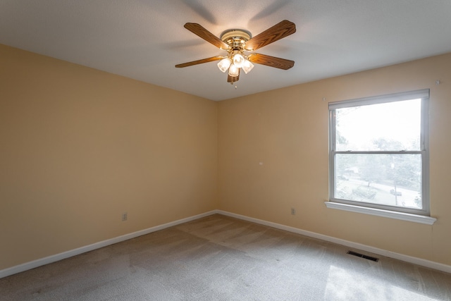 unfurnished room featuring light colored carpet and ceiling fan