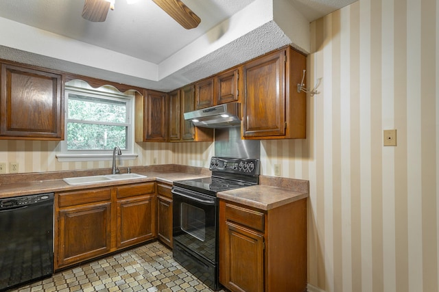 kitchen with a raised ceiling, black appliances, light tile patterned floors, sink, and ceiling fan