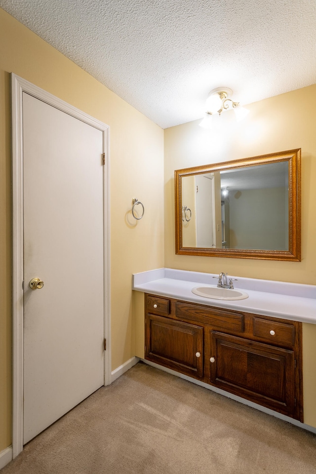 bathroom featuring a textured ceiling and vanity