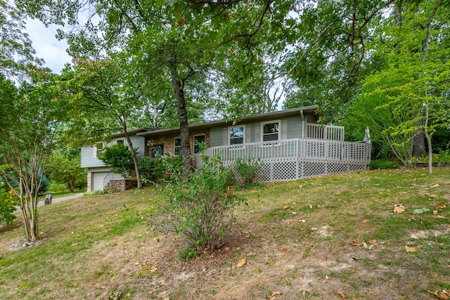 ranch-style home featuring a wooden deck and a garage