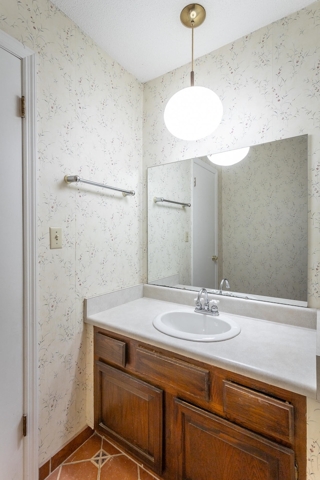 bathroom featuring tile patterned floors, a textured ceiling, and vanity