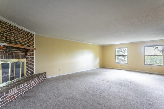 unfurnished living room featuring carpet flooring, crown molding, a textured ceiling, and a brick fireplace