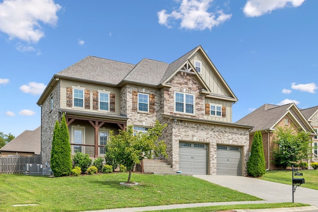 craftsman inspired home with a front lawn and a garage