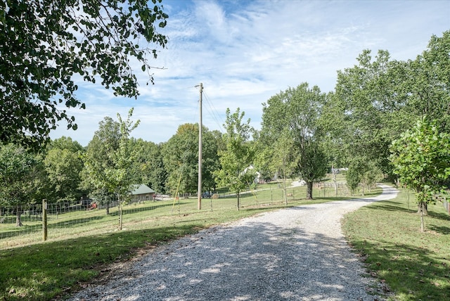 view of home's community with a lawn and a rural view