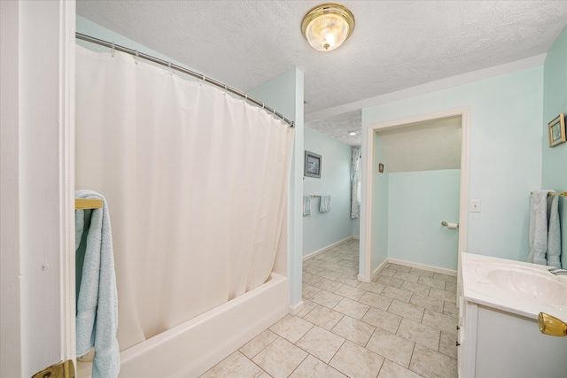 bathroom featuring shower / bath combo, vanity, a textured ceiling, and tile patterned flooring