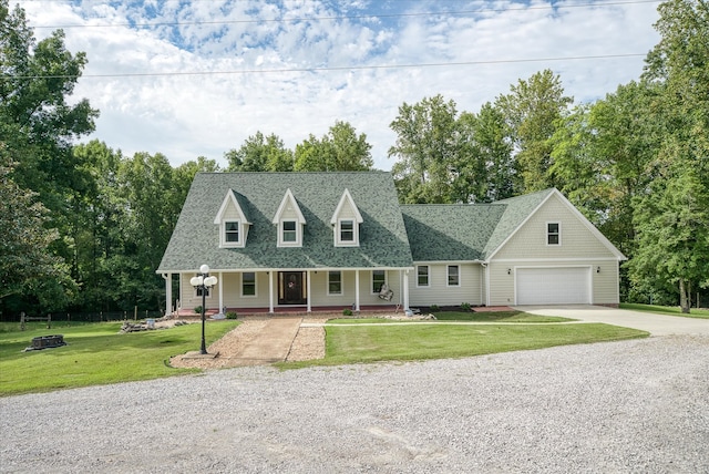 cape cod house featuring a front yard, a porch, and a garage