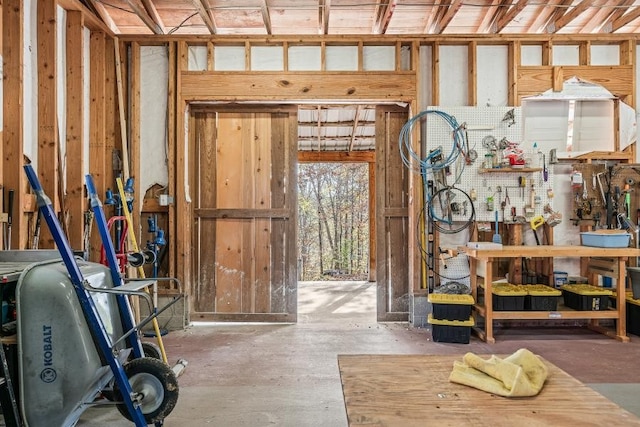 miscellaneous room with a workshop area and concrete floors