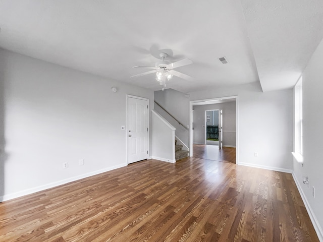 empty room featuring dark hardwood / wood-style flooring and ceiling fan