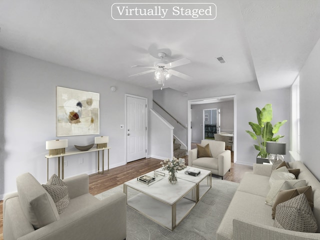 living room with light wood-type flooring and ceiling fan