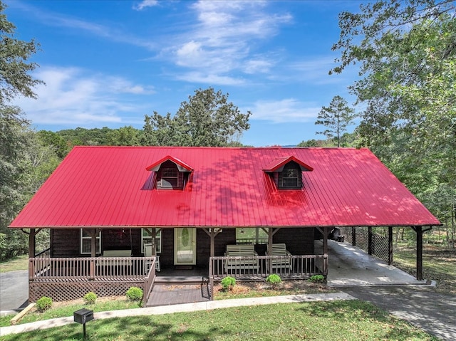 cape cod home featuring a carport and a porch