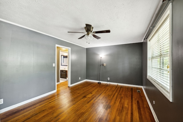 spare room featuring ceiling fan, hardwood / wood-style flooring, and a textured ceiling