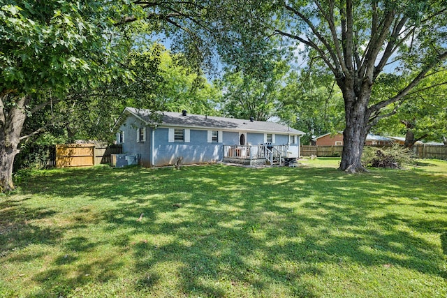 back of property featuring a yard and a deck