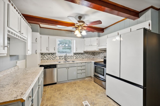 kitchen with ornamental molding, stainless steel appliances, sink, ceiling fan, and beam ceiling