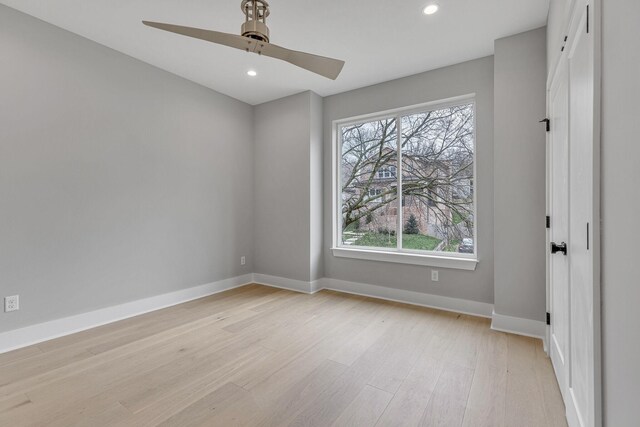 unfurnished bedroom with multiple windows, ceiling fan, and light hardwood / wood-style floors