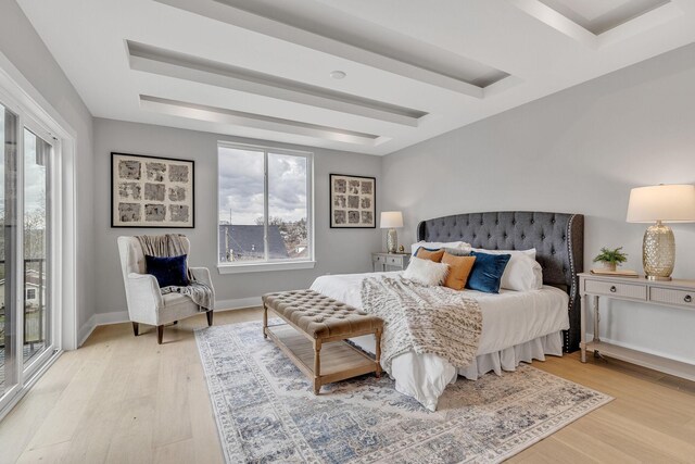 bedroom with access to outside and light hardwood / wood-style floors