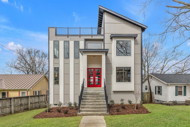 view of front of home featuring a balcony and a front lawn