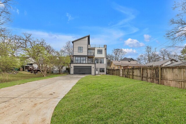 view of front of property with a front yard and a garage