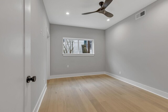 empty room featuring ceiling fan and light hardwood / wood-style flooring