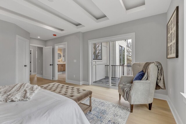 bedroom featuring light wood-type flooring and ensuite bathroom