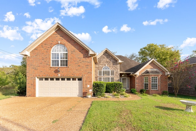 view of property with a garage and a front lawn