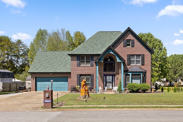 view of front of property featuring a front yard and a garage