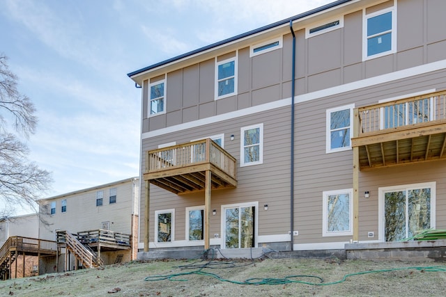 rear view of property featuring a wooden deck