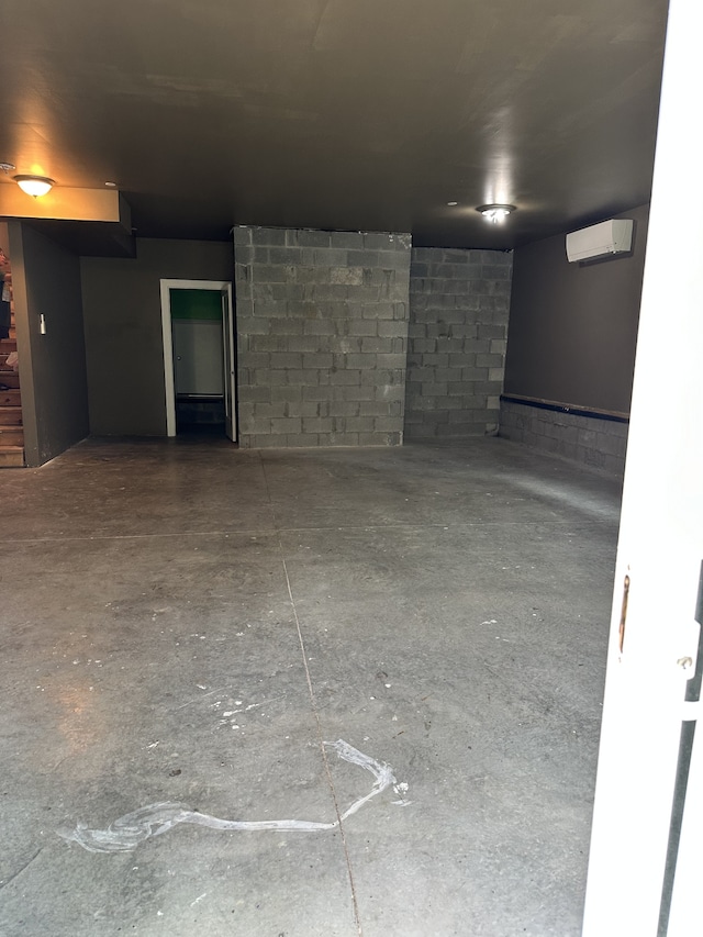 interior space with a wall unit AC and concrete floors