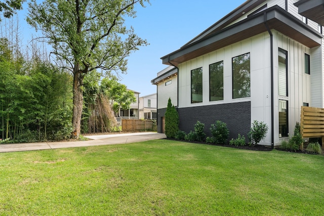 view of side of home featuring a yard