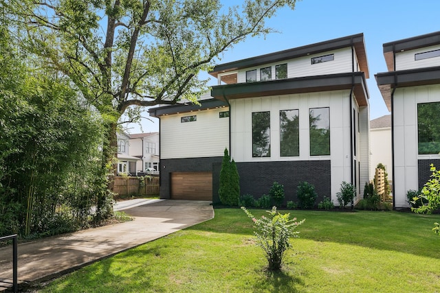 view of front facade with a garage and a front lawn