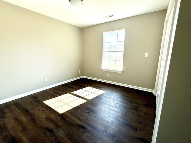 unfurnished room with wood-type flooring