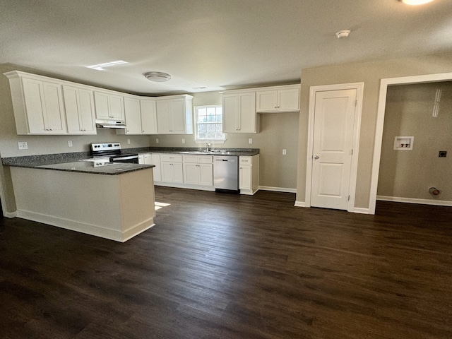 kitchen with dark wood-type flooring, stainless steel appliances, kitchen peninsula, and white cabinetry