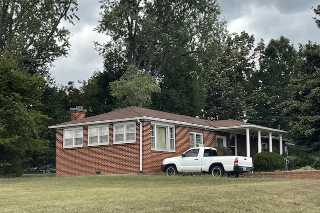 105 Northgate Dr, Mcminnville, TN 37110 - view of front facade featuring a front lawn, a chimney, brick siding, and crawl space