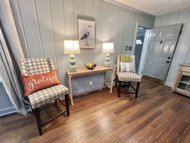 living area featuring wood walls and dark hardwood / wood-style floors