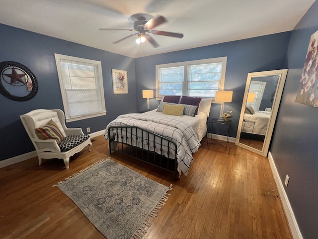 bedroom with ceiling fan and hardwood / wood-style flooring